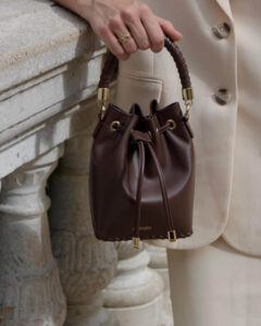 The bucket bag has a round bottom and a tall body