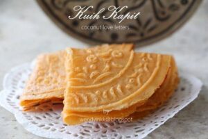 A thin and crispy biscuit folded into quarters, often with pretty patterns on the surface.