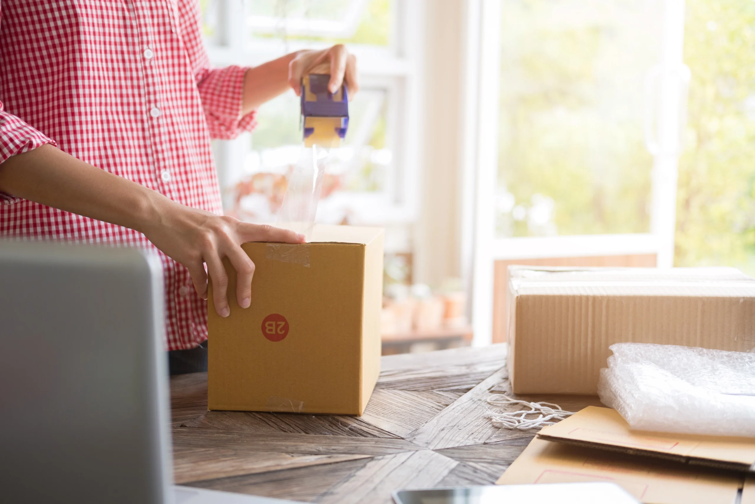 midsection-woman-preparing-parcel